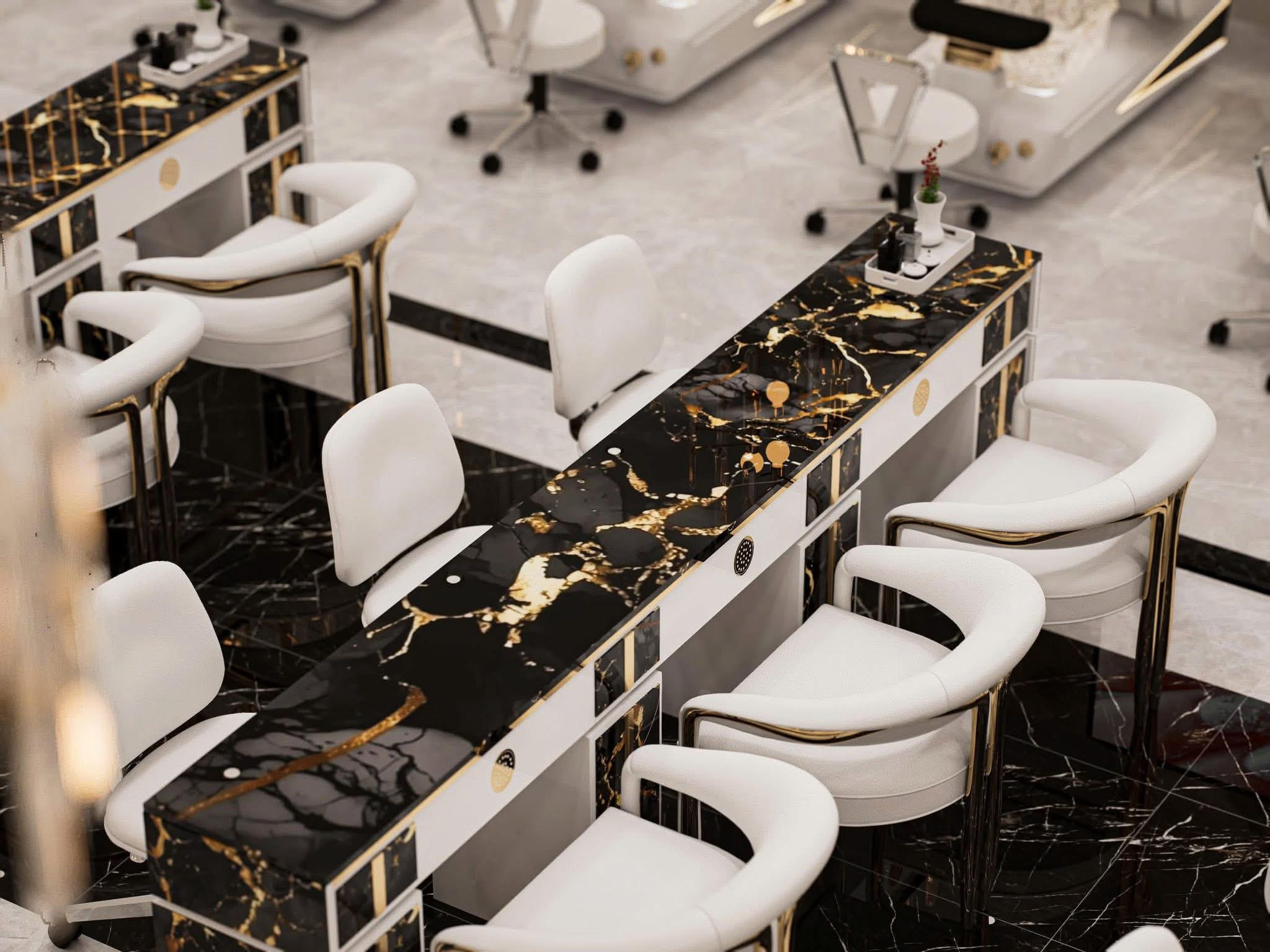 Close-up of black marble nail tables with gold veining