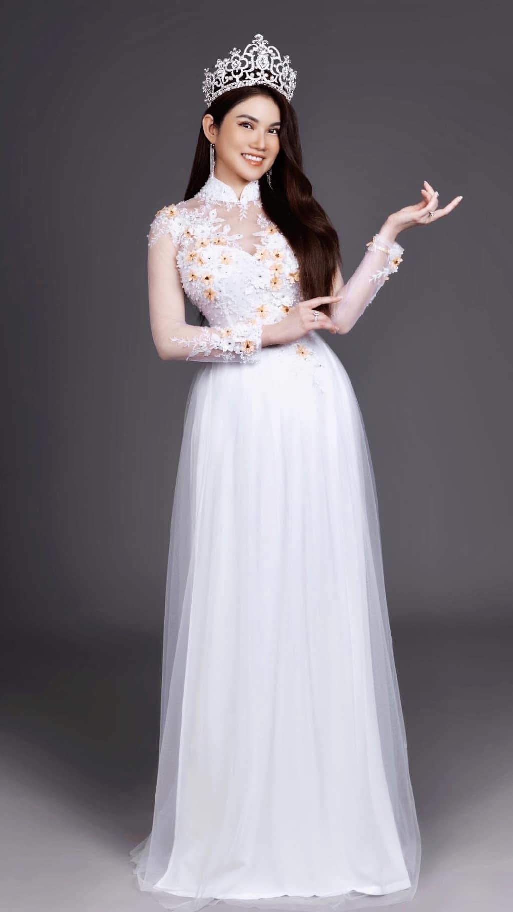 The founder and Beauty Queen owner of Glo Nail Spa, wearing a crown and elegant white gown